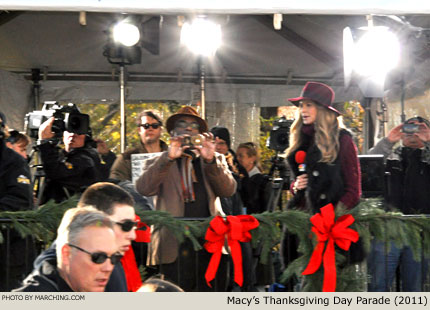 Al Roker captures video on a smartphone while Elle Macpherson looks on. 2011 Macy's Thanksgiving Day Parade Photo by Marching.com