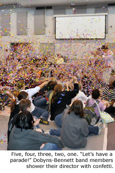 With a chant of let's have a parade, Dobyns-Bennett H.S. band members shower their director with confetti.