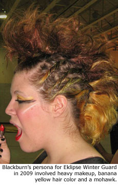 Blackburn's persona for Eklipse Winter Guard in 2009 involved heavy makeup, banana yellow hair color and a mohawk.